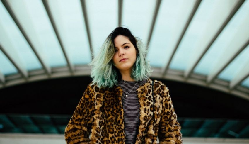 A woman in a leopard print coat posing for a photo.
