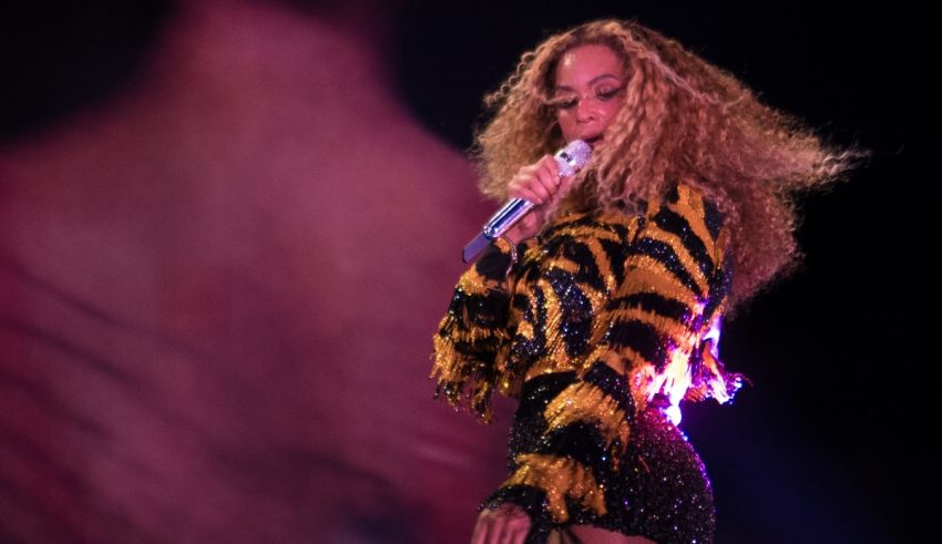 Beyonce performs on stage in a zebra print outfit.