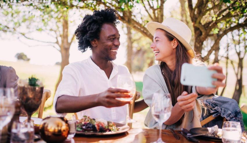 A group of people taking a selfie at a picnic table.