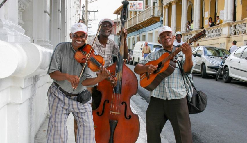 Three men with musical instruments on a street in havana.