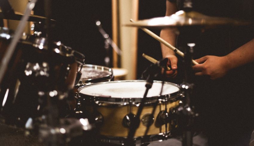 A person playing drums in a recording studio.