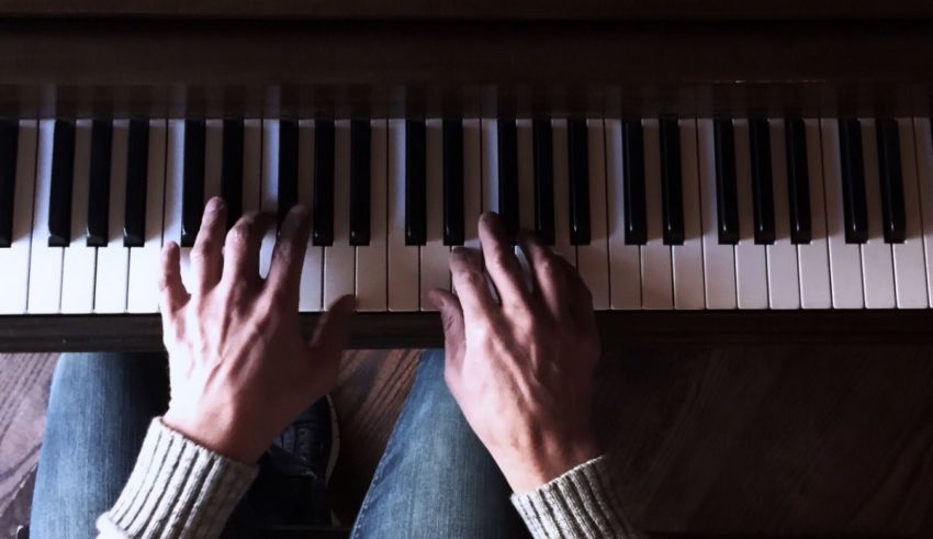 A person's hands on a piano.