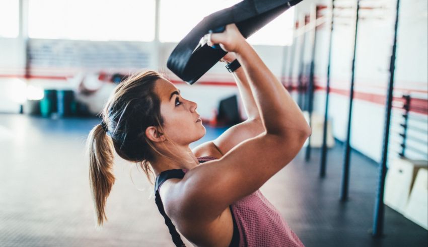 A woman doing squats in a gym.