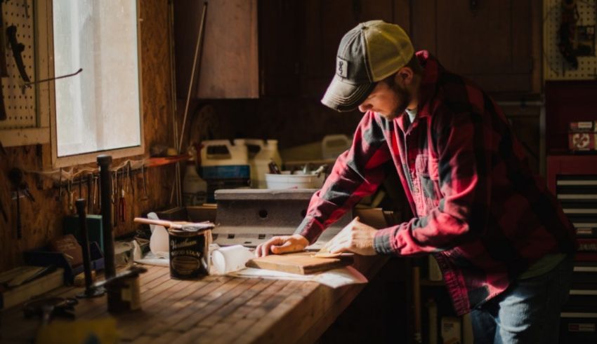 A man working on a piece of wood in a workshop.