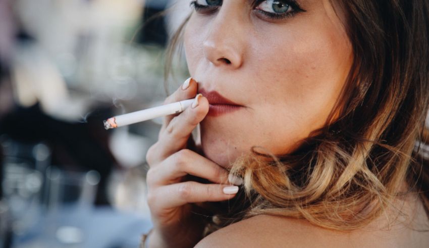 A woman is smoking a cigarette in a restaurant.