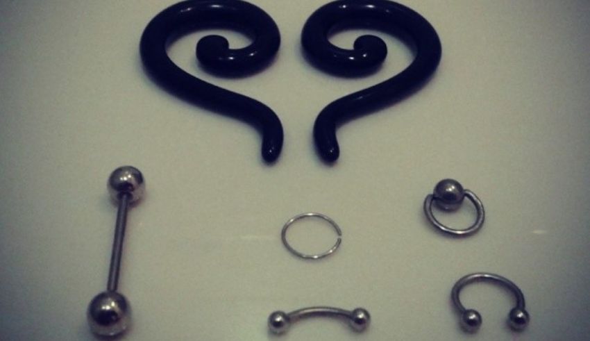 A set of black ear piercings and rings.