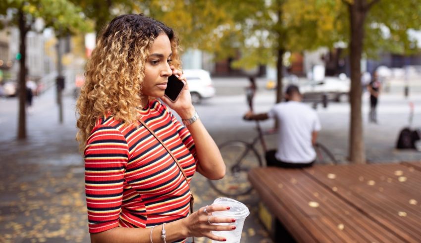 A woman talking on a cell phone in a park.