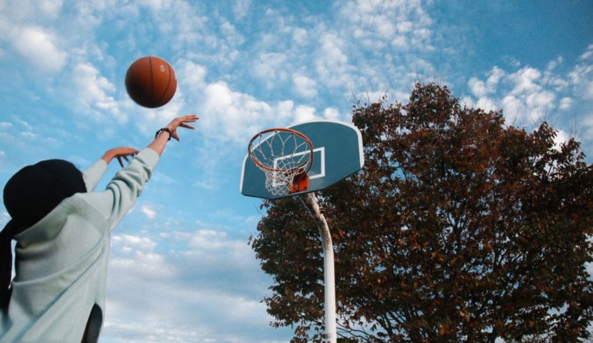A girl dribbling a basketball into a hoop.