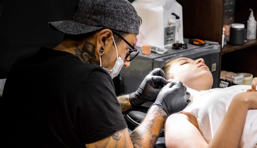 A woman getting a tattoo at a tattoo shop.