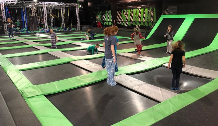 Kids playing on trampoline at an indoor trampoline park.