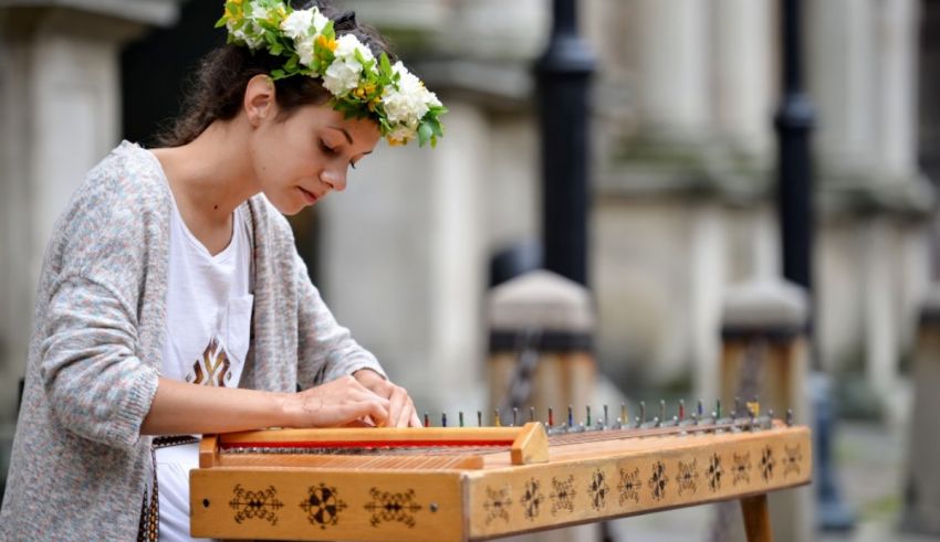 A young woman playing a musical instrument on the street.