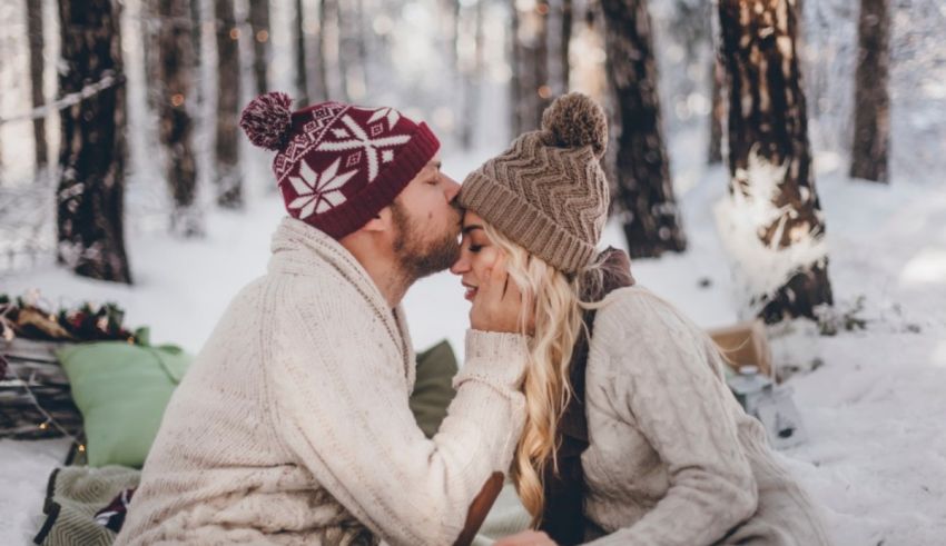 A couple kissing in the snow.
