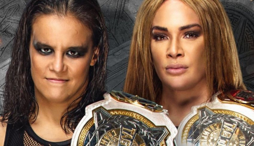 Two women are standing next to each other with wwe belts.