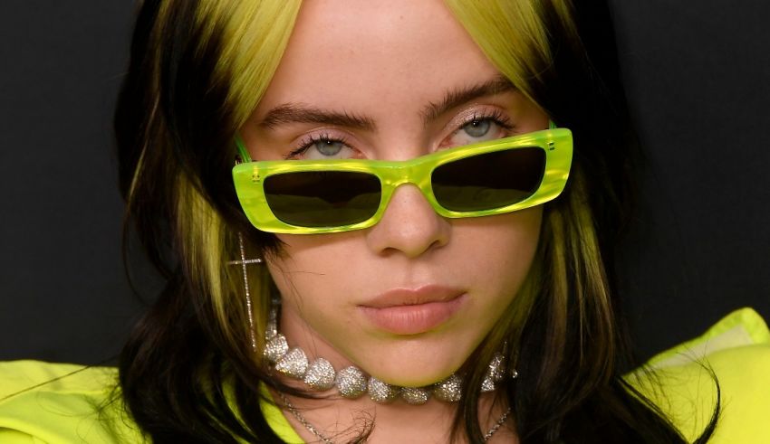 A woman in neon yellow sunglasses is posing for a photo.