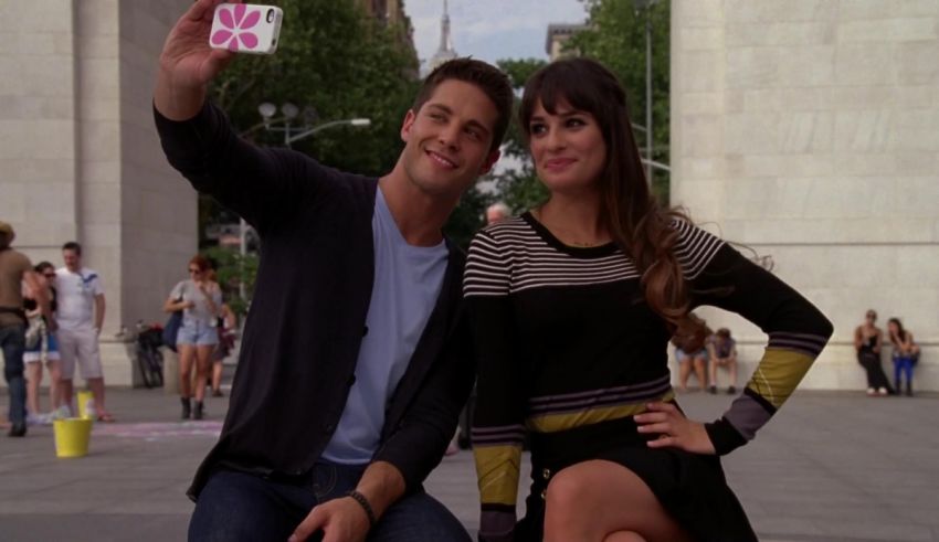 A man and woman taking a selfie in front of a building.