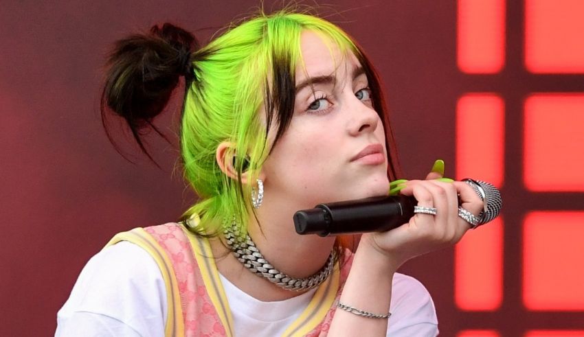 A woman with green hair holding a microphone.