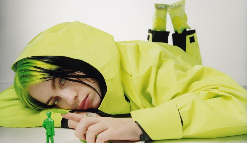 A woman in a green jacket laying on a table with a toy.