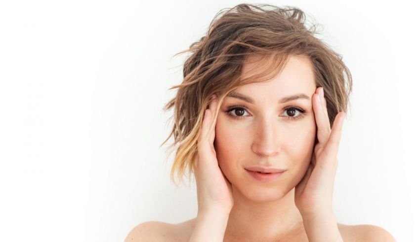 A young woman with her hands on her face.