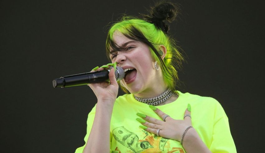 A woman with green hair singing into a microphone.