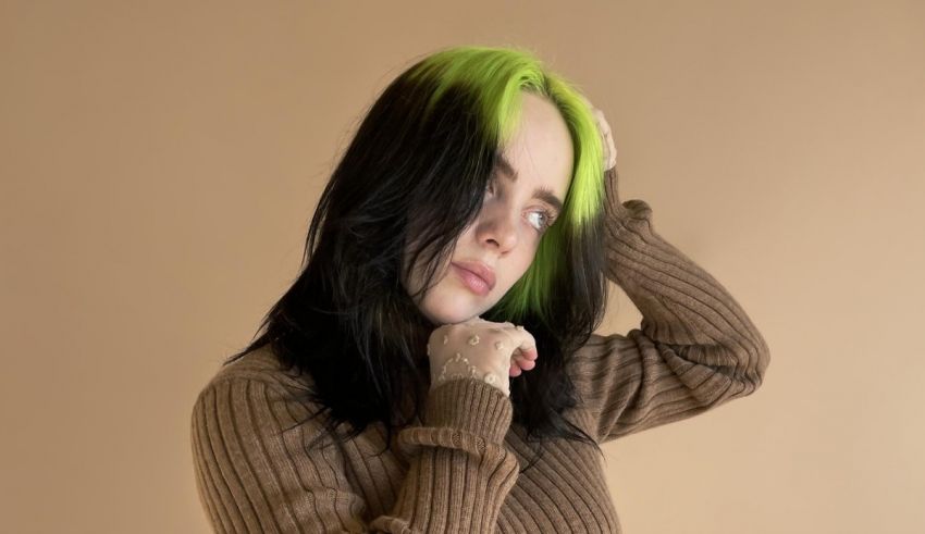 A woman with green hair posing on a beige background.