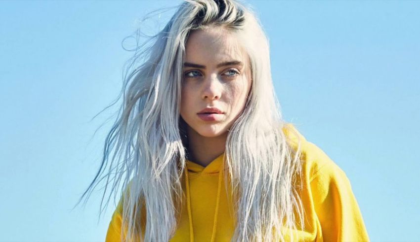 A woman with white hair in a yellow hoodie.