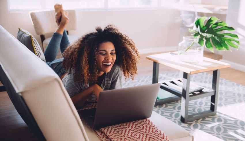 A young woman using a laptop in her living room.