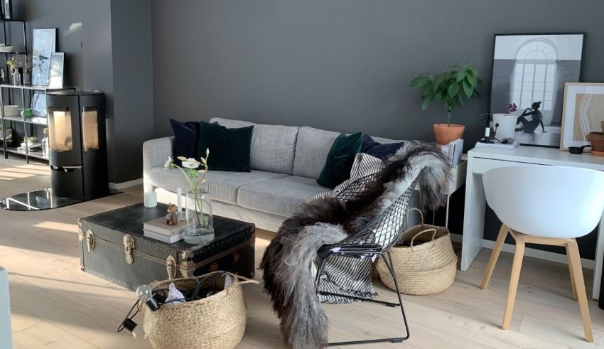 A living room with grey walls and furniture.