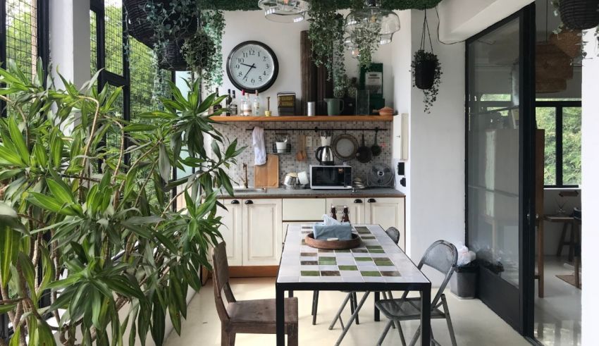 A kitchen and dining area with plants and a clock.
