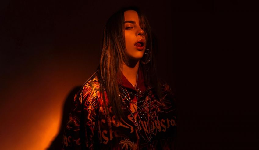 A woman with long hair standing in a dark room.