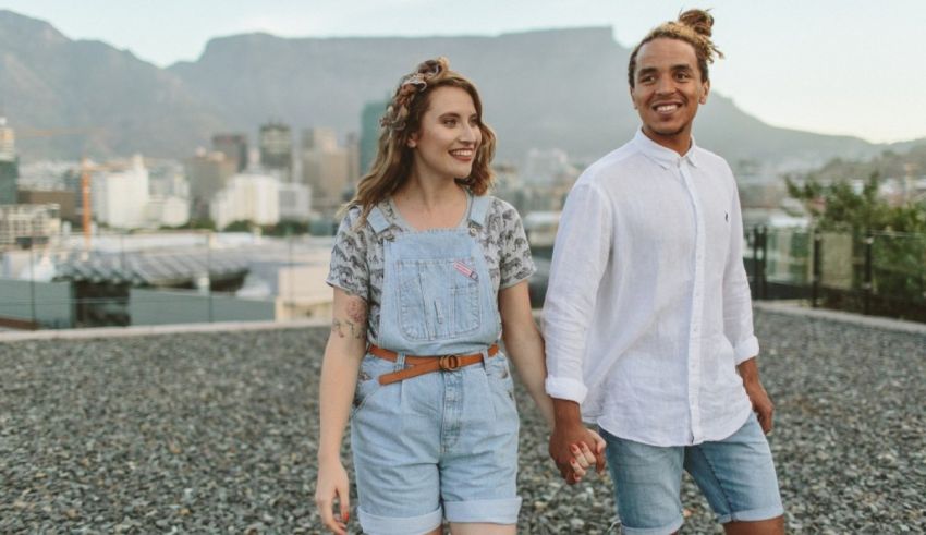 A young couple holding hands on a rooftop in cape town.