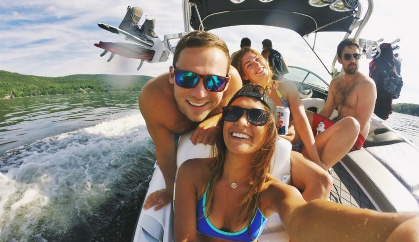 A group of people on a boat taking a selfie.