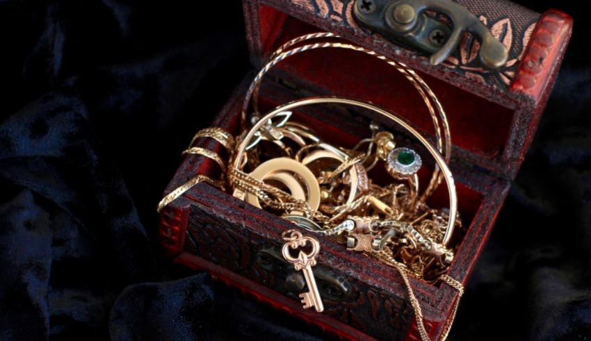 A chest filled with gold jewelry and a key.