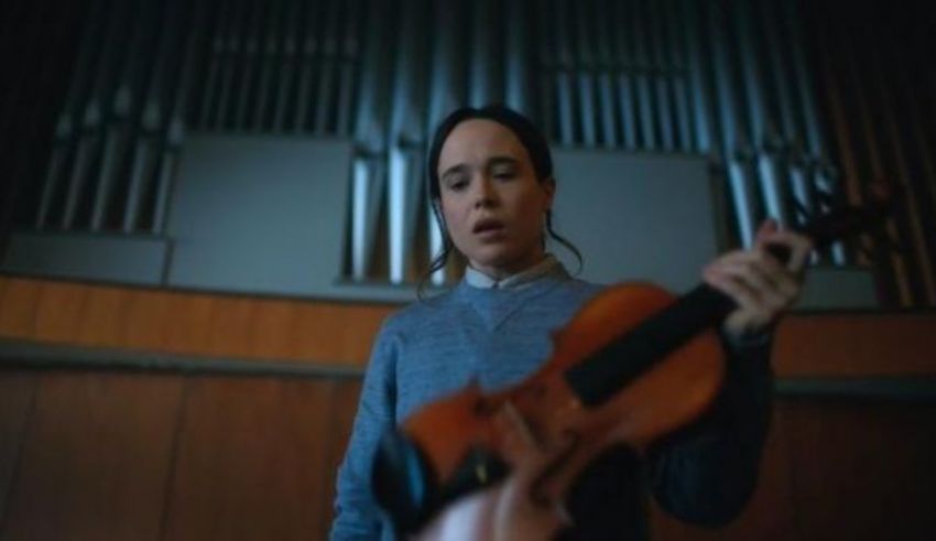 A woman playing a violin in a church.