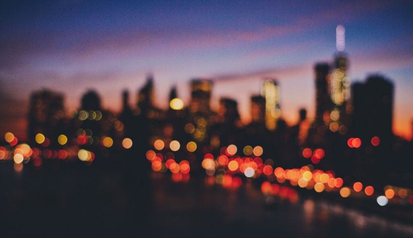 A blurry image of a city skyline at dusk.