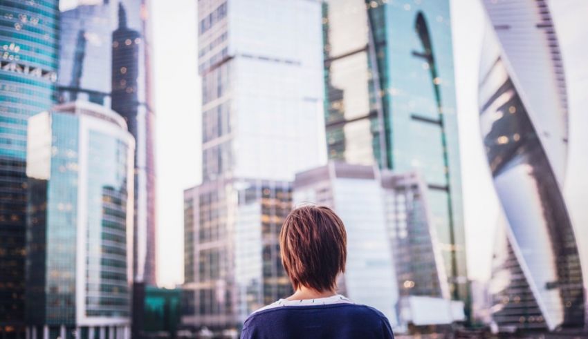 A woman looking out over a city skyline.