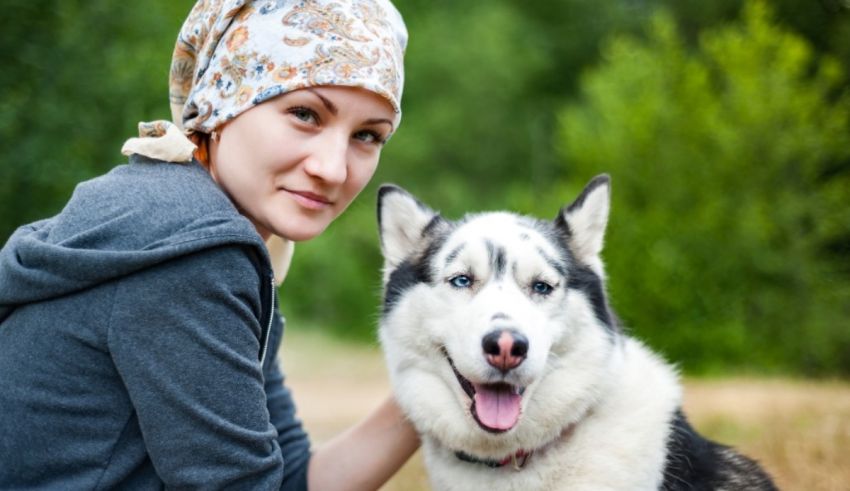 A young woman with a husky dog.