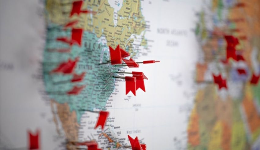 Red pins on a map of the world.