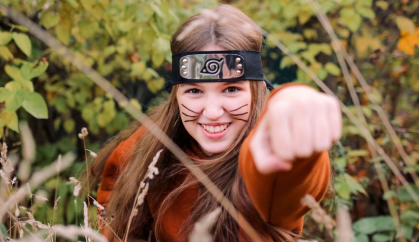 A girl wearing a ninja headband pointing to the camera.
