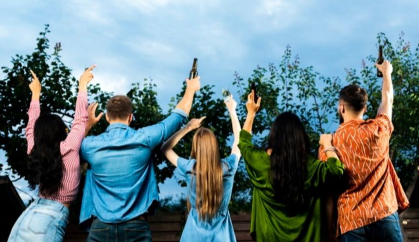 A group of friends raising their hands in the air.