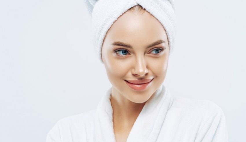 A young woman in a white towel posing for a photo.