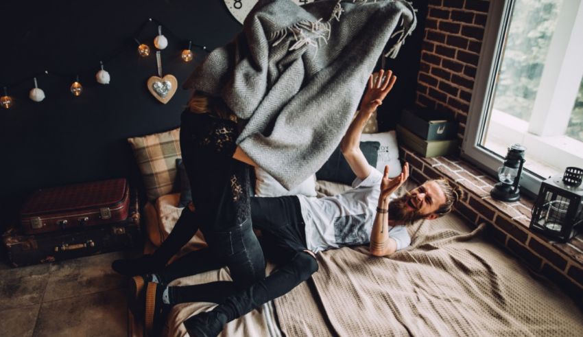 A man and woman on a bed.