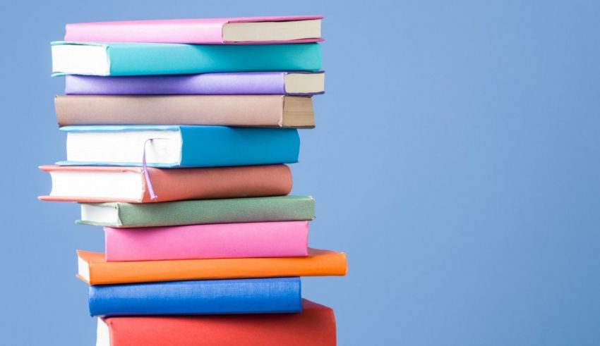 A stack of colorful books on a blue background.