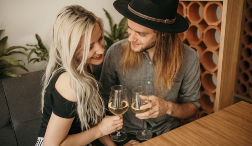 A couple drinking wine at a restaurant.