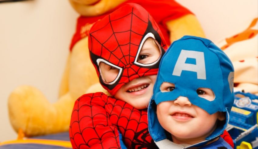 Two children dressed up in superhero costumes.