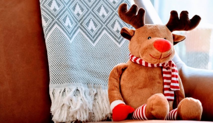 A stuffed reindeer sitting on a chair.