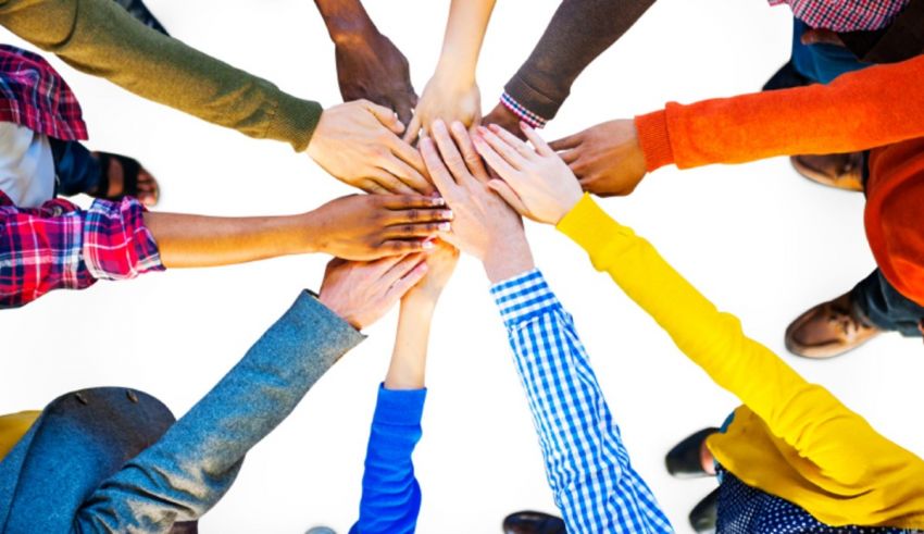 A group of people holding hands in a circle.