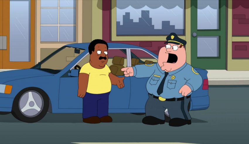 A man is talking to a police officer in front of a car.