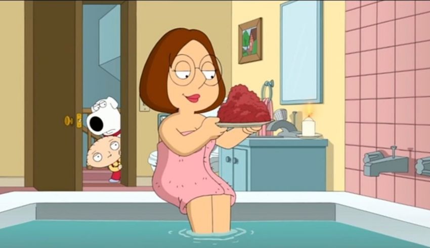 A woman in a bath tub holding a piece of cake.