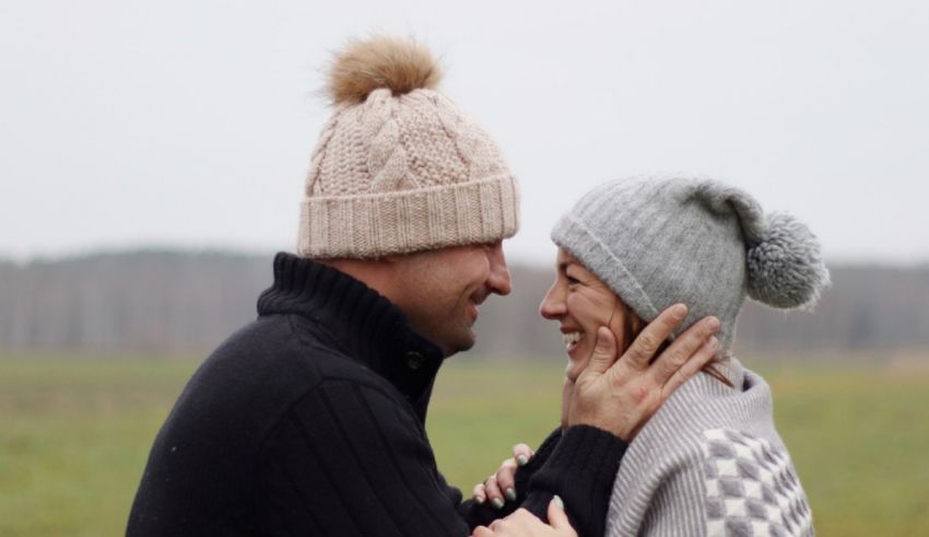 A man and woman in knit hats.