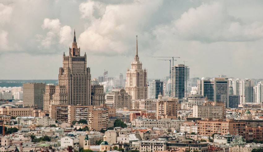 A view of a city with tall buildings and a cloudy sky.